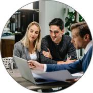 Techpullers mobile app development team consulting with clients, discussing strategy with a laptop and documents in Kochi