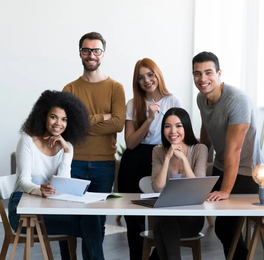 Diverse team of five digital marketing professionals smiling in an office, highlighting the expertise and collaborative spirit at a leading digital marketing company in Kochi, Kerala.