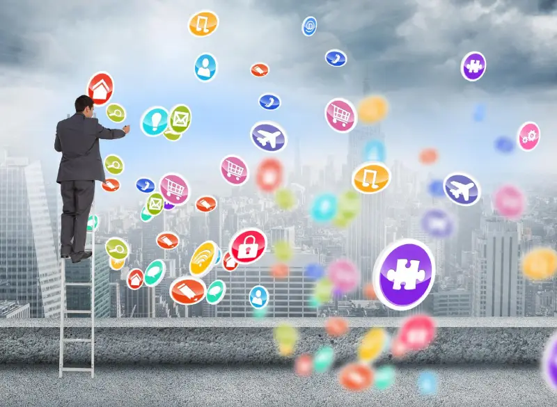 A businessman standing on a ladder and interacting with floating social media icons against a cityscape background, symbolizing the comprehensive social media marketing services provided by Techpullers.