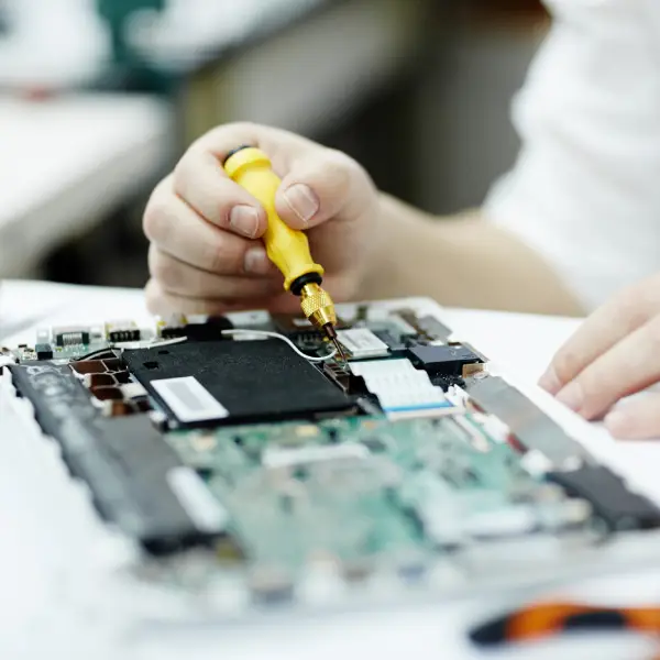 Person using a screwdriver on a computer motherboard, representing TechPullers' development of a one-stop solution for Accurate Systems to enhance user experience and service accessibility for computer needs.