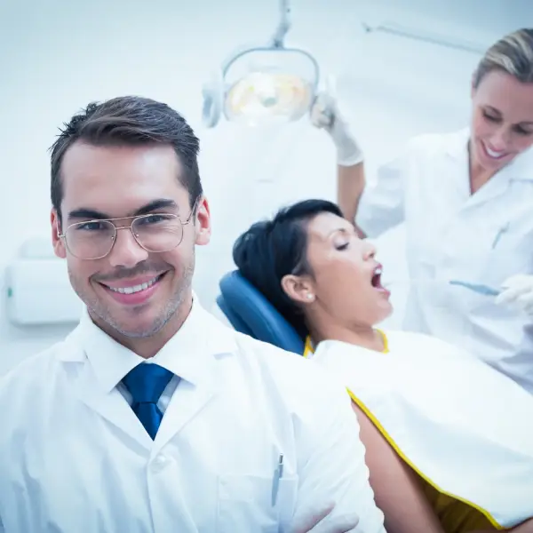 Dentist and patient in a dental clinic, representing TechPullers' website development for Javadent in Kozhikode, focusing on user experience and specialist care promotion.