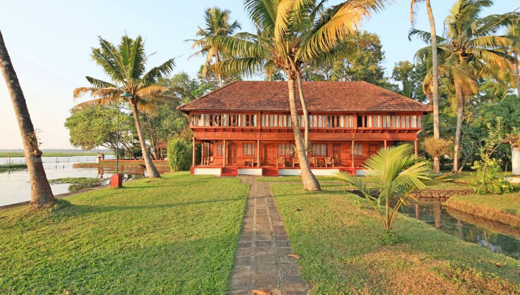 Traditional Kerala riverside stay surrounded by nature.