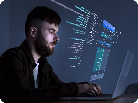 Custom web design showcase on Techpullers website - designer working on responsive layouts and user experience optimization with desktop and laptop screens