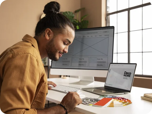 Custom web design showcase on Techpullers website - designer working on responsive layouts and user experience optimization with desktop and laptop screens