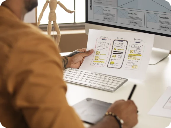 UI/UX design and website redesign services - designer reviewing wireframes and layouts for responsive, user-friendly website interface